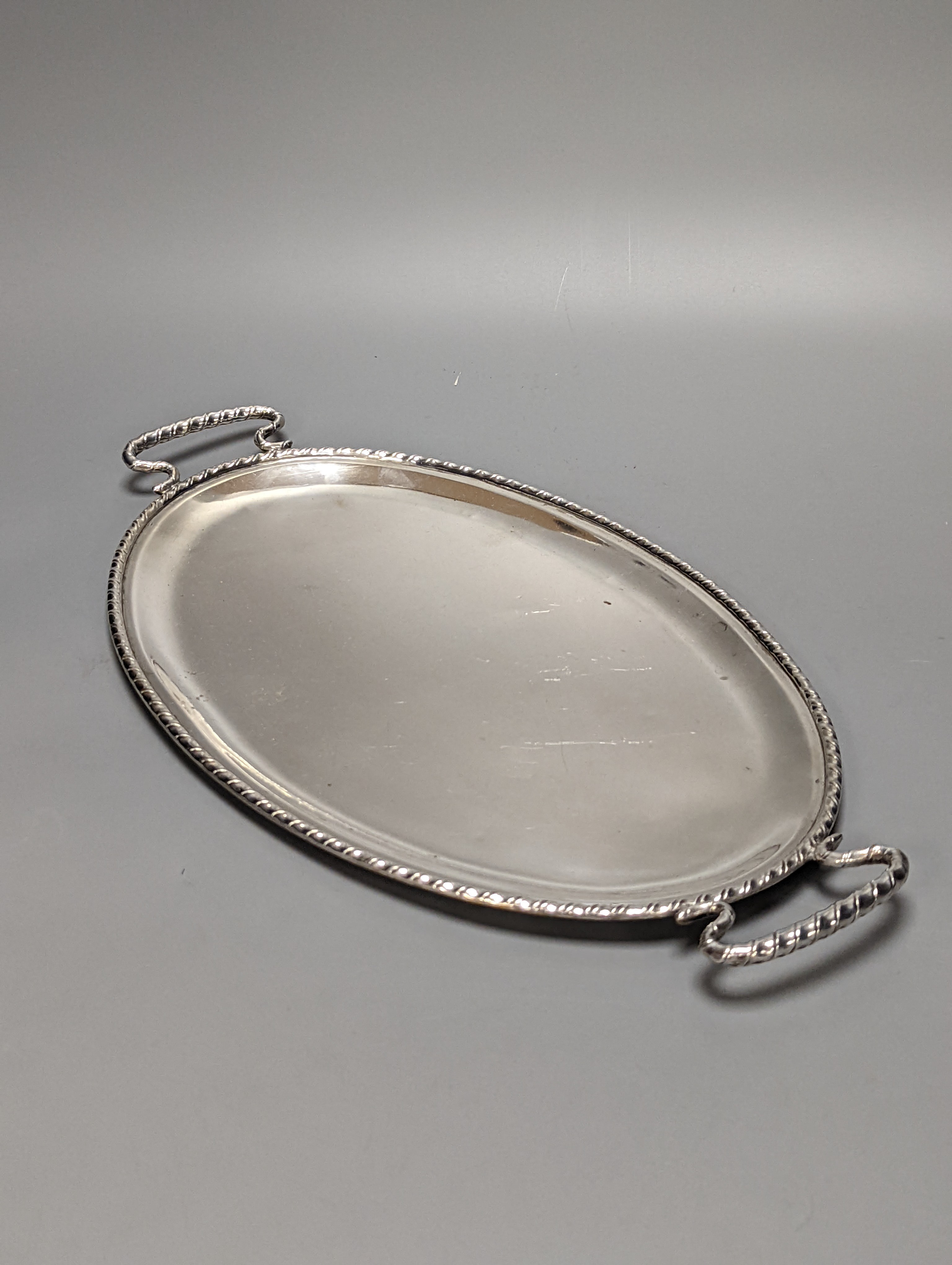 A Persian? white metal oval gallery tray, 45.7cm and an Italian 800 standard two handled oval tea tray